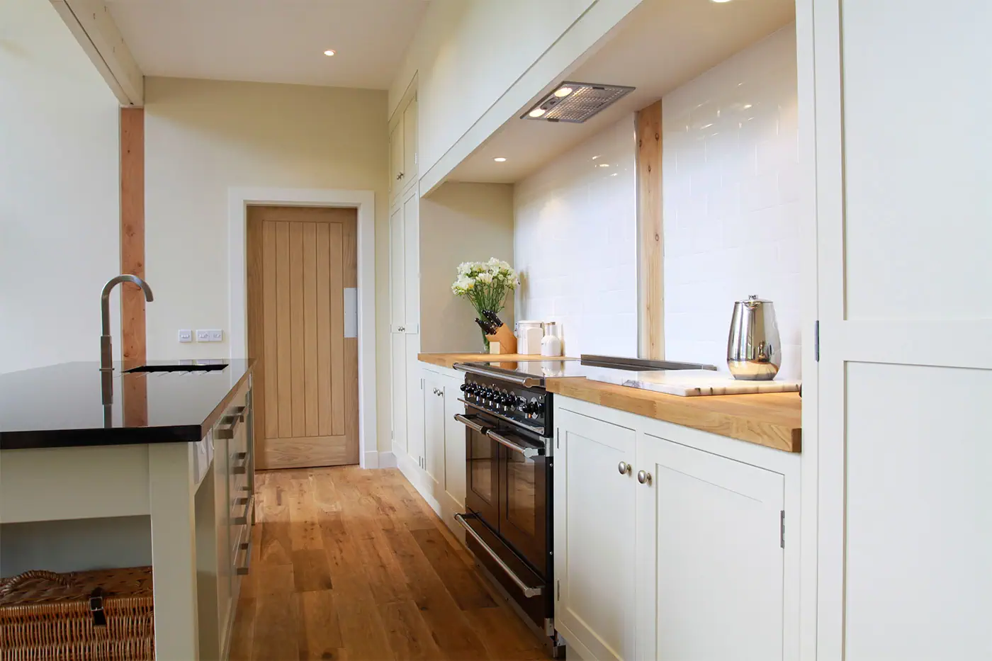A kitchen scene with wooden flooring