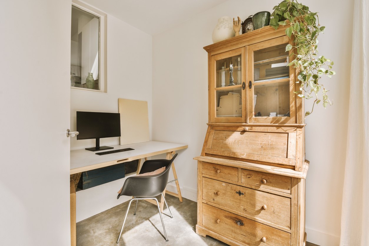A home office with a desk and a hutch