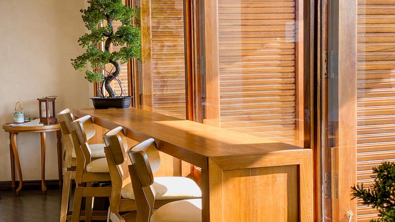 A wooden table surrounded by chairs