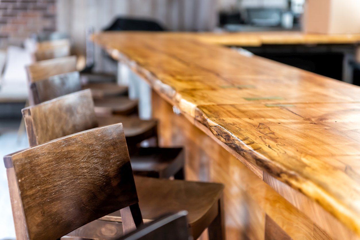 A wooden bar counter with a natural finish