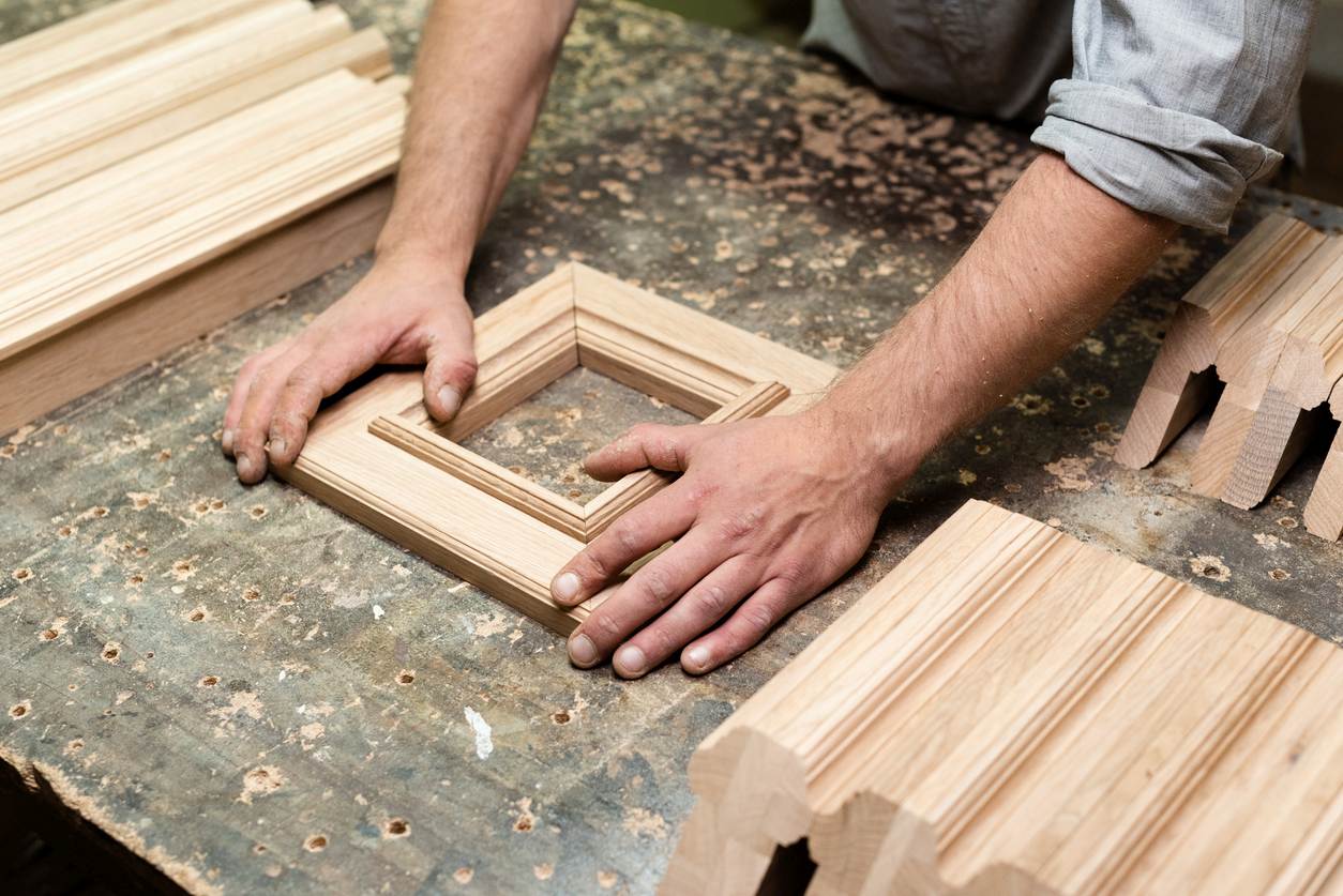The carpenter assembles the frame for the panel